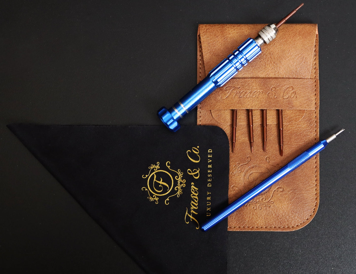 Blue pen and tool set with leather pouch on a black background