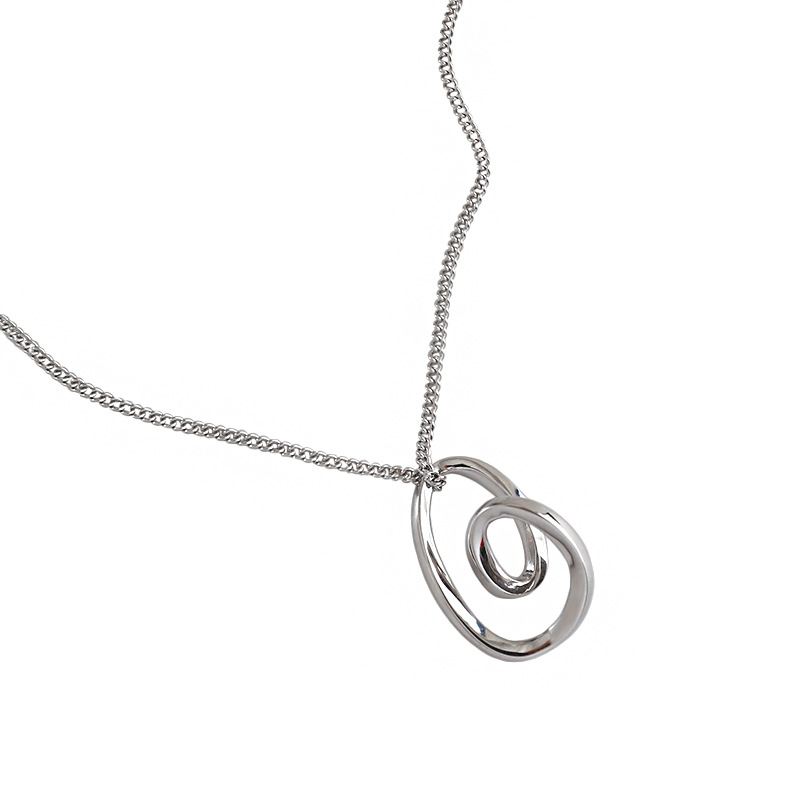 Silver necklace with a spiral pendant on a white background