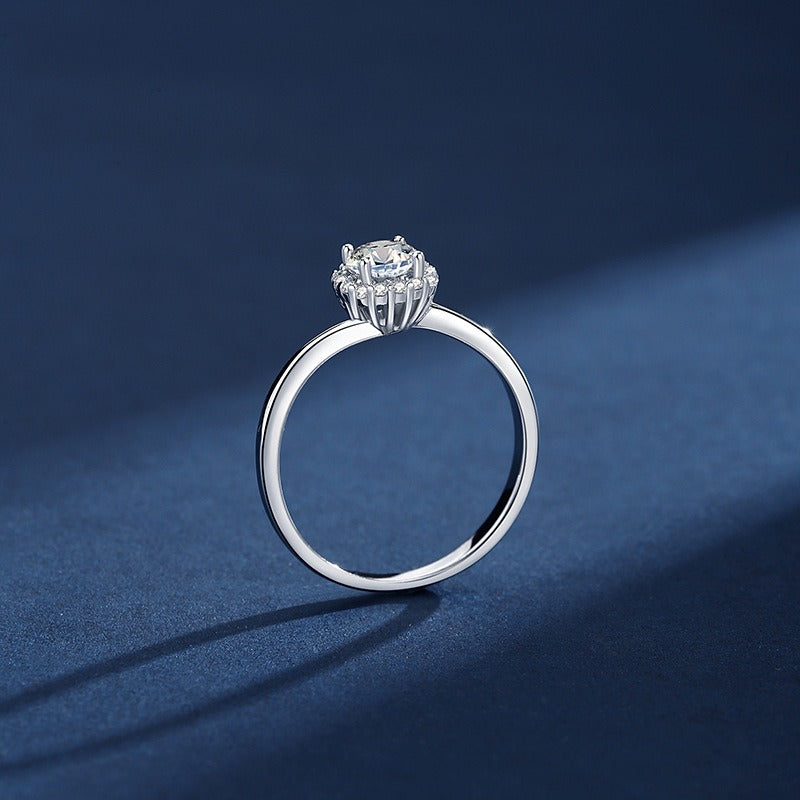 Silver ring with a diamond on a blue background