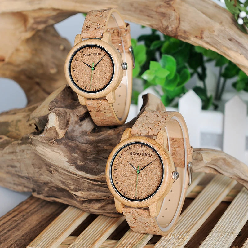 Two wooden watches with cork straps on a natural wood background