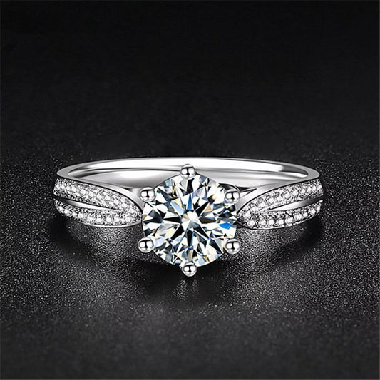 Silver ring with a large diamond on a dark background