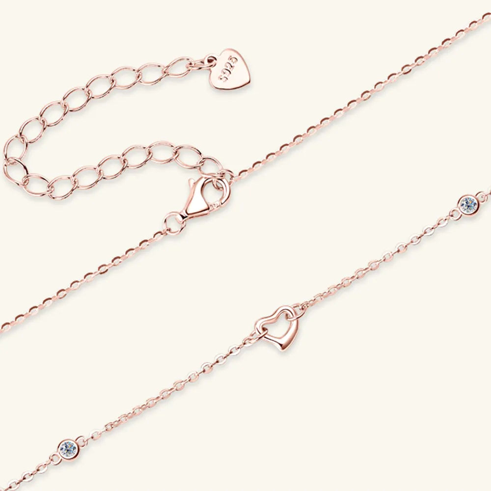 Rose gold anklets with heart-shaped clasp on a white background