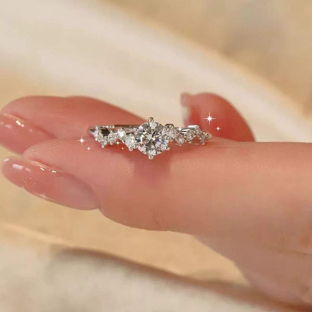 Diamond ring on a finger with a soft focus background
