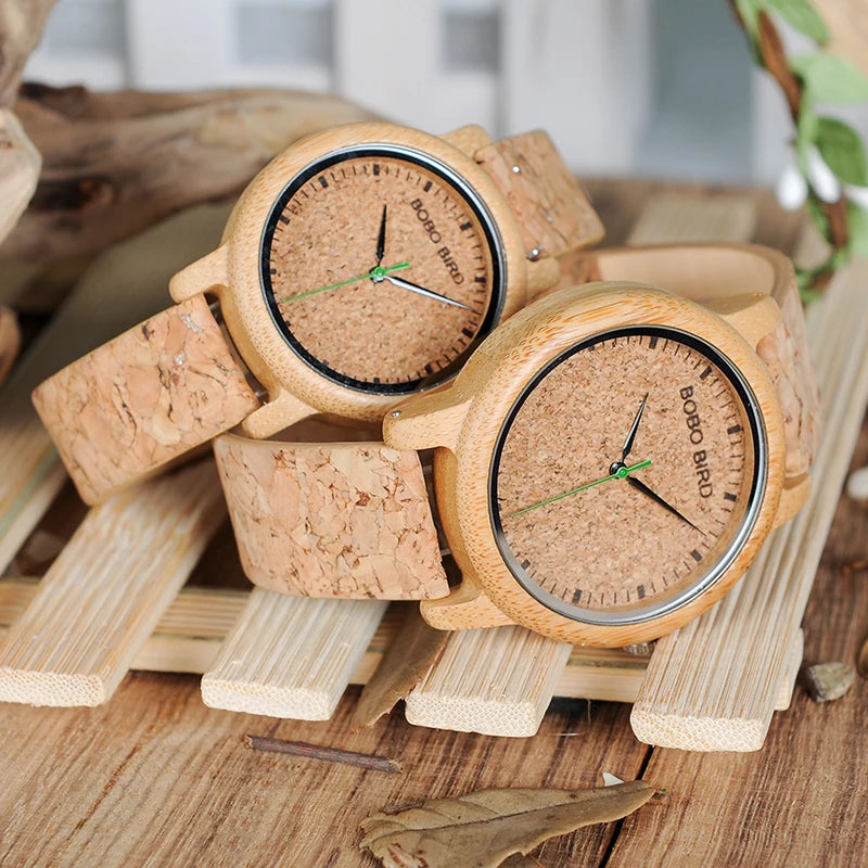 Two wooden watches on a wooden stand with a natural background