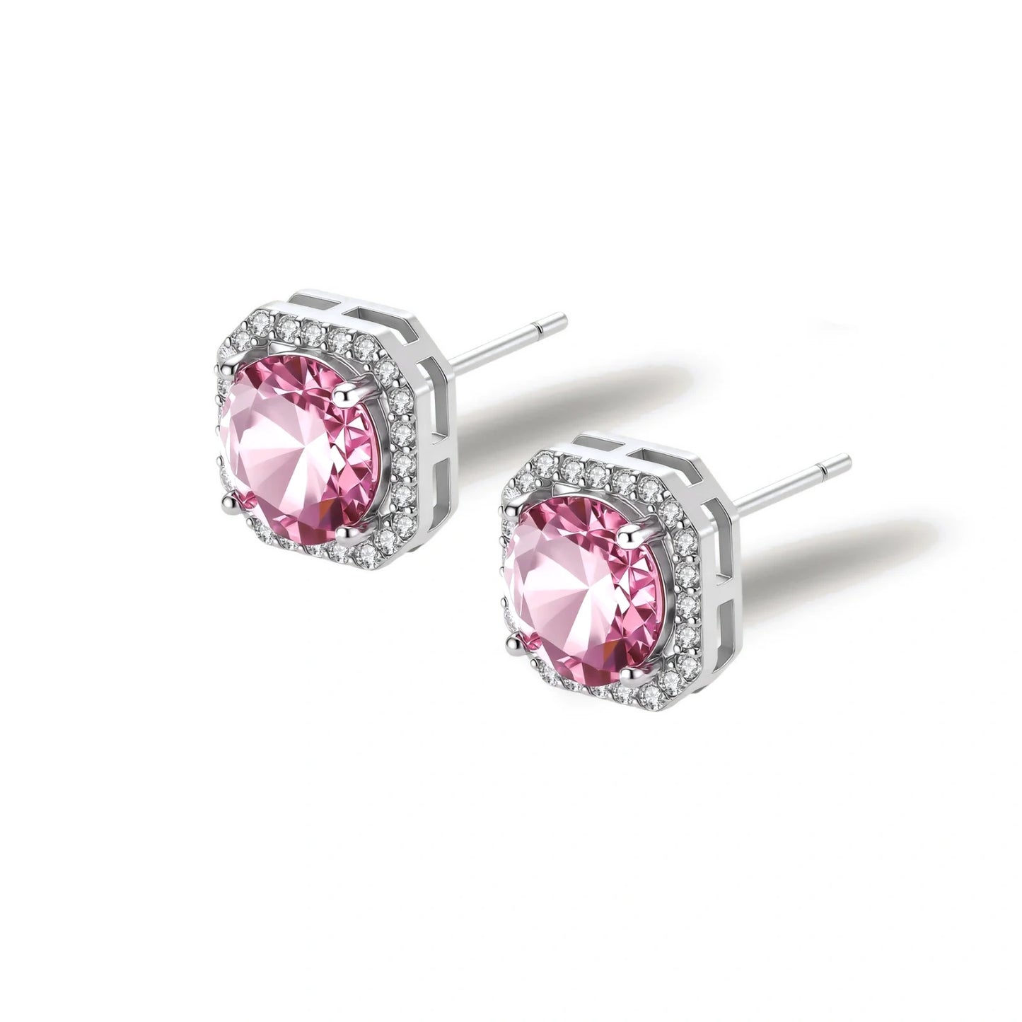 Pink moissanite studs in octagonal sterling silver halo settings with sparkling accent stones on cream background.