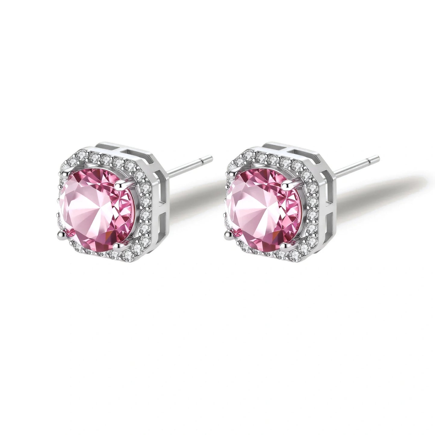 Pink moissanite studs in octagonal sterling silver halo settings with sparkling accent stones on cream background.