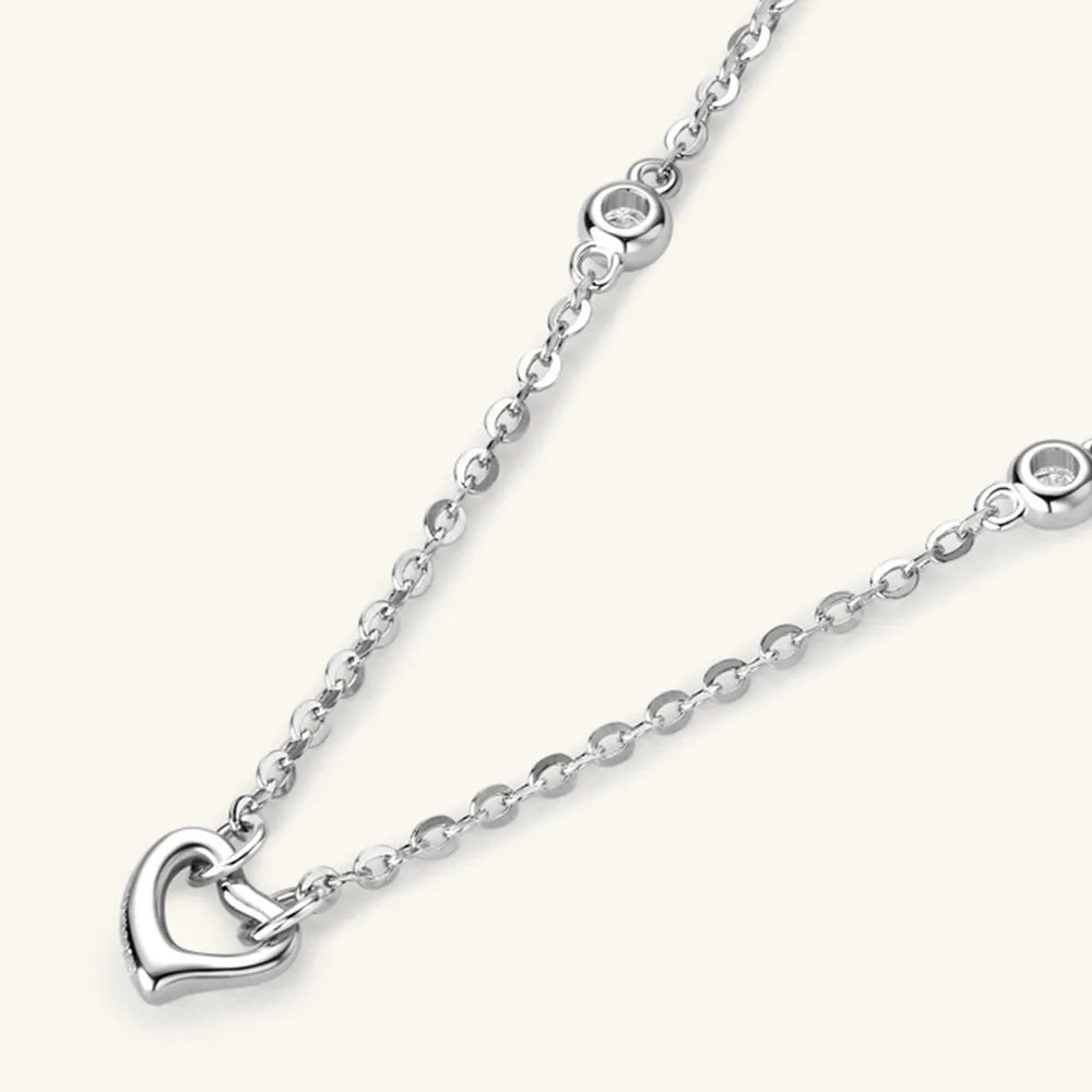 Silver necklace with a heart pendant on a white background