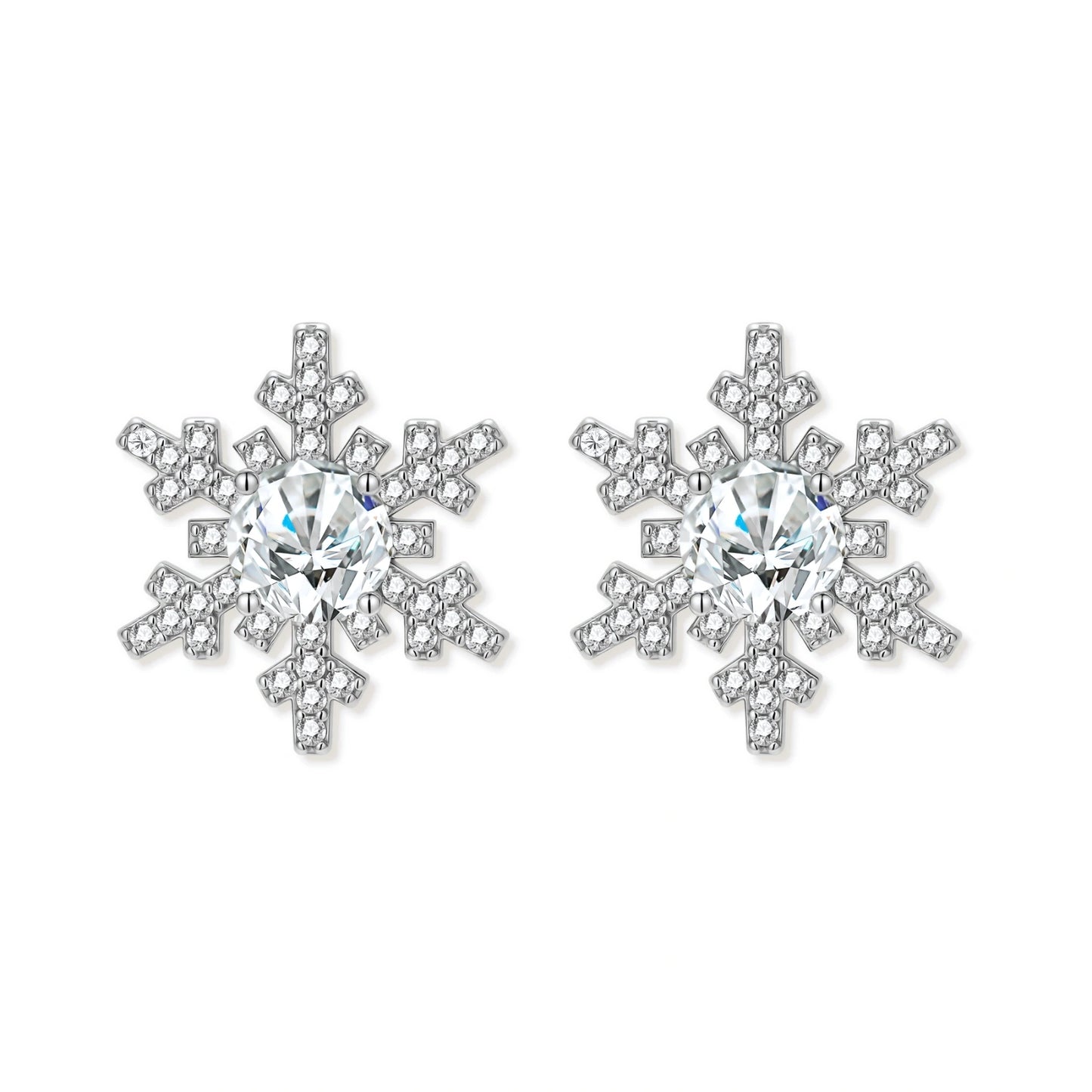 Sterling silver snowflake stud earrings with brilliant moissanite centers and intricate geometric patterns on cream background