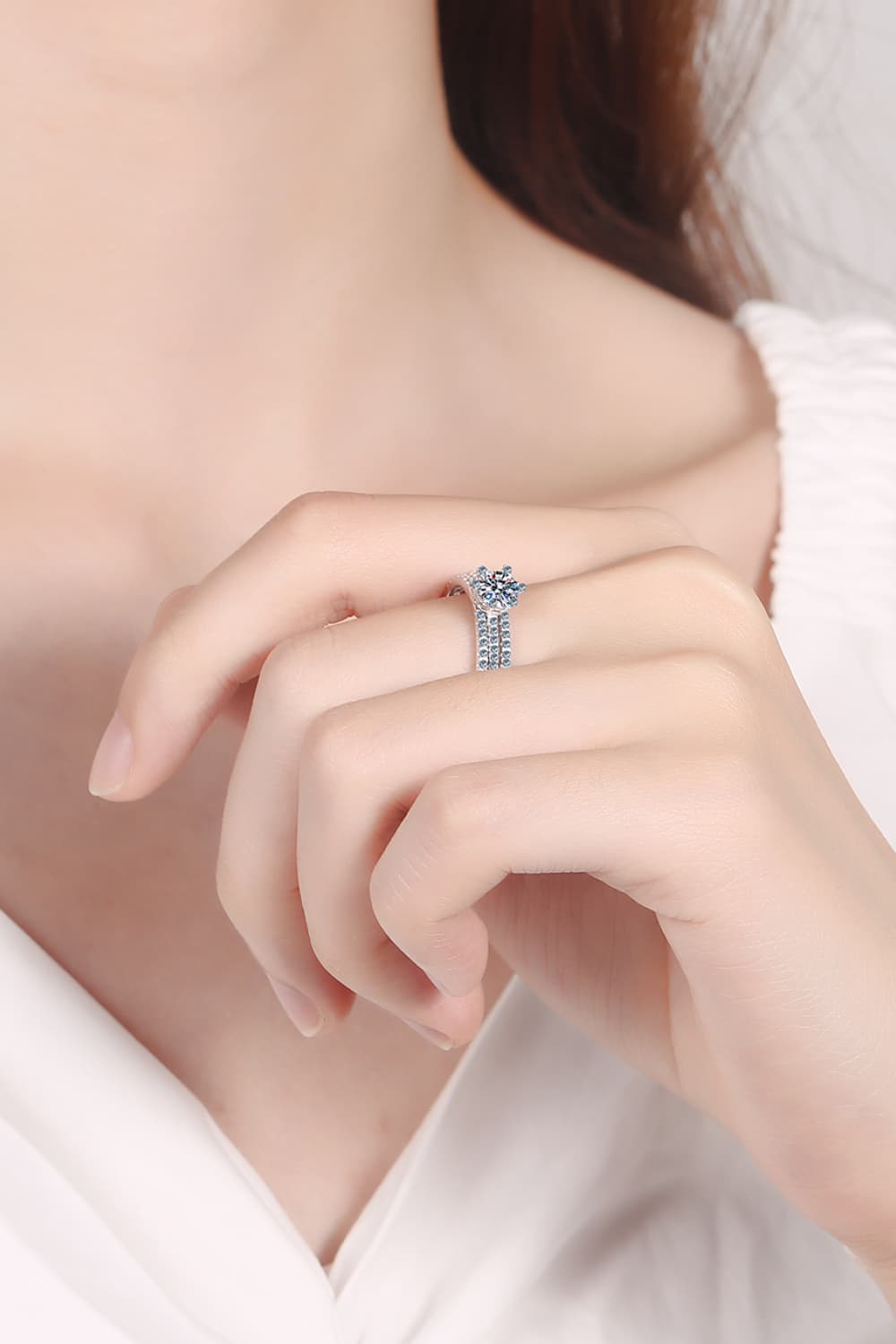Close-up of a 0.5 Carat Moissanite Solitaire Ring in 925 Sterling Silver on a hand | Le'Var Neilson Jewelry