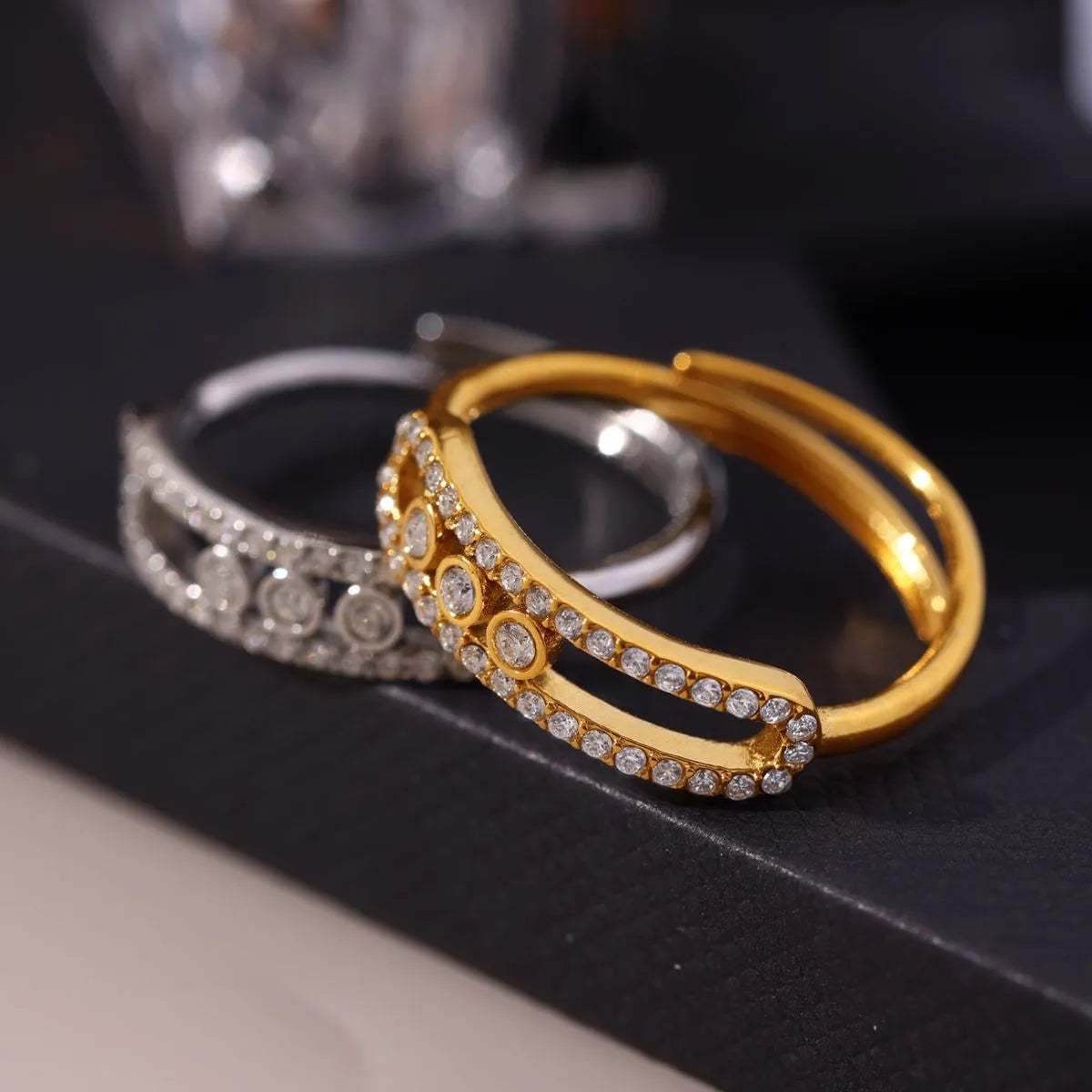 Gold and silver hoop earrings on a dark surface