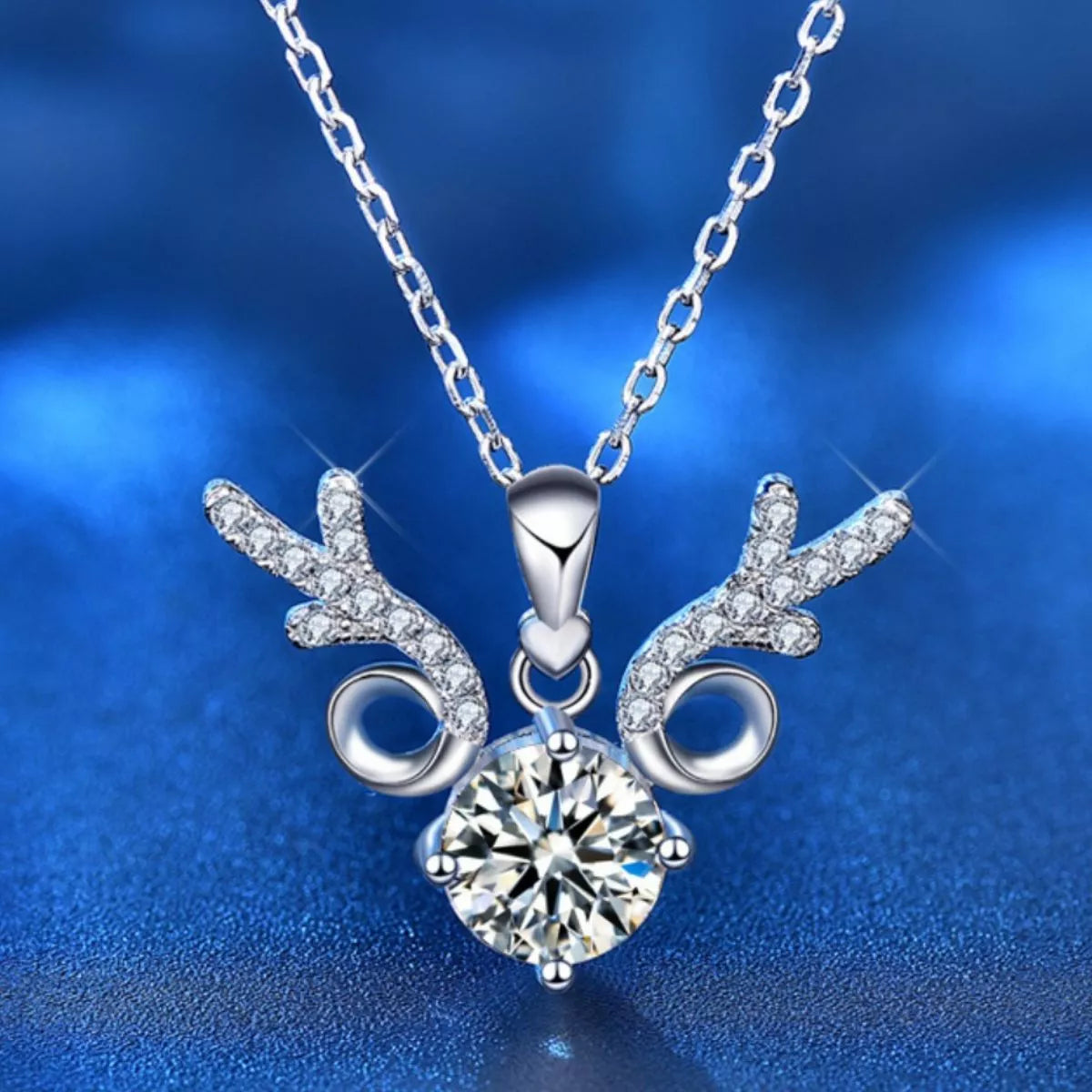Silver necklace with a diamond pendant on a blue background