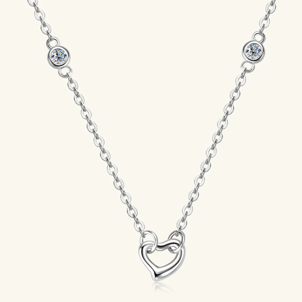 Silver necklace with a heart-shaped pendant on a white background