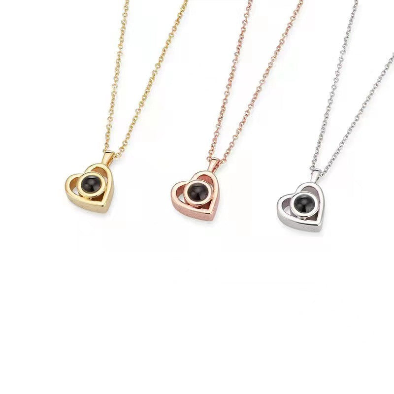 Three heart-shaped pendants on gold, rose gold, and silver chains against a white background.