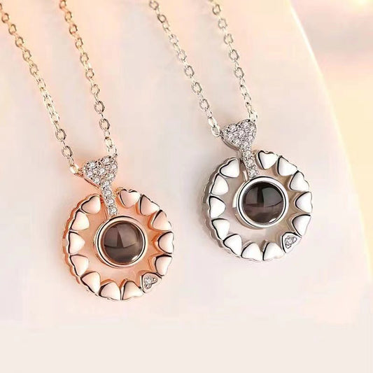 Two necklaces with circular pendants featuring gemstones on a soft background