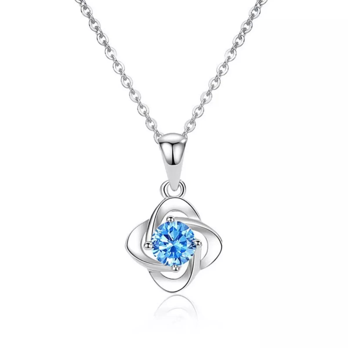 Silver necklace with a blue gemstone pendant on a white background