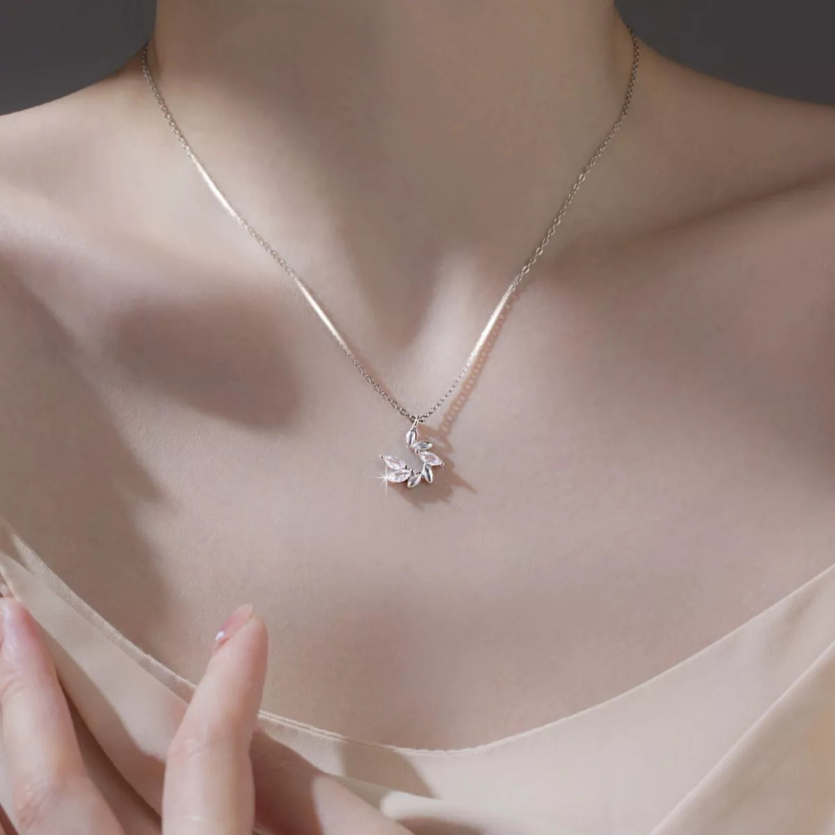 Necklace with a delicate pendant on a mannequin neck against a neutral background