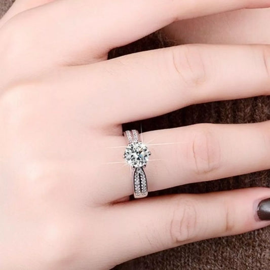Close-up lifestyle view of a 3 Carat Moissanite geometric ring in a 925 sterling silver setting worn on a hand with a brilliant sparkle effect | Le'Var Neilson Jewelry