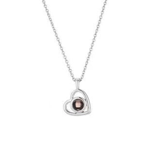 Heart-shaped pendant necklace with a gemstone on a white background