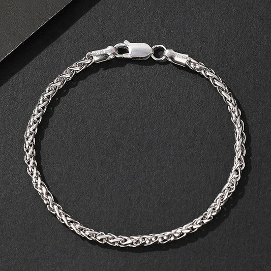 Silver chain bracelet on a black background