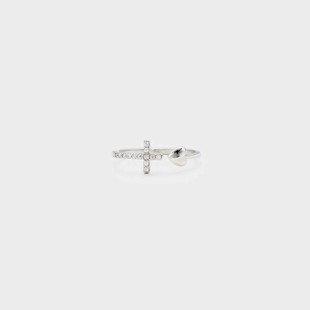 Silver ring with a cross design on a light gray background