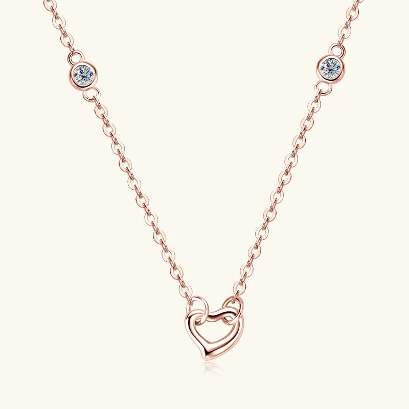 Rose gold necklace with a heart-shaped pendant on a white background