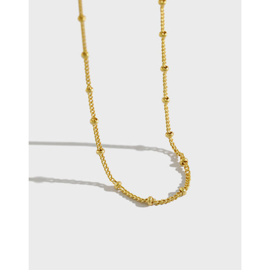 Gold chain necklace on a white background