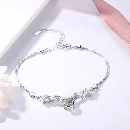 Silver bracelet with floral design on a white background