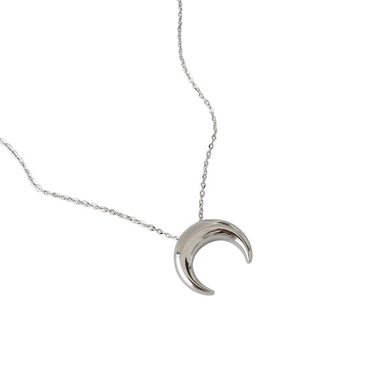 Silver crescent moon necklace on a white background