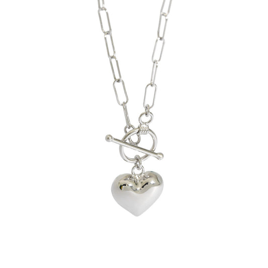 Silver heart-shaped pendant on a chain against a white background