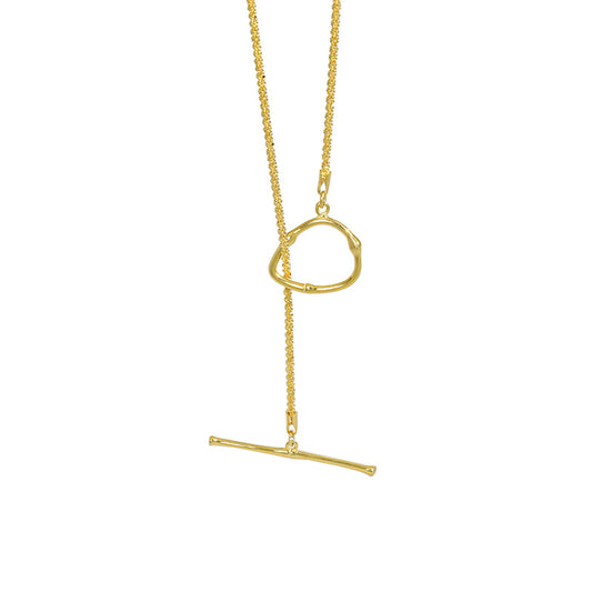 Gold necklace with a unique pendant design on a white background