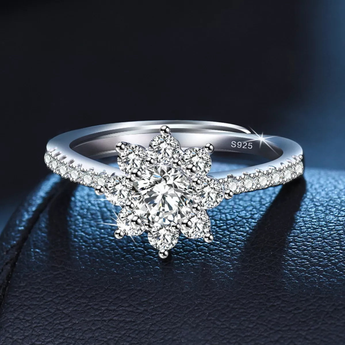 Silver ring with star-shaped diamond on a dark background