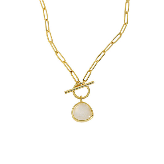 Gold necklace with a white pendant on a white background