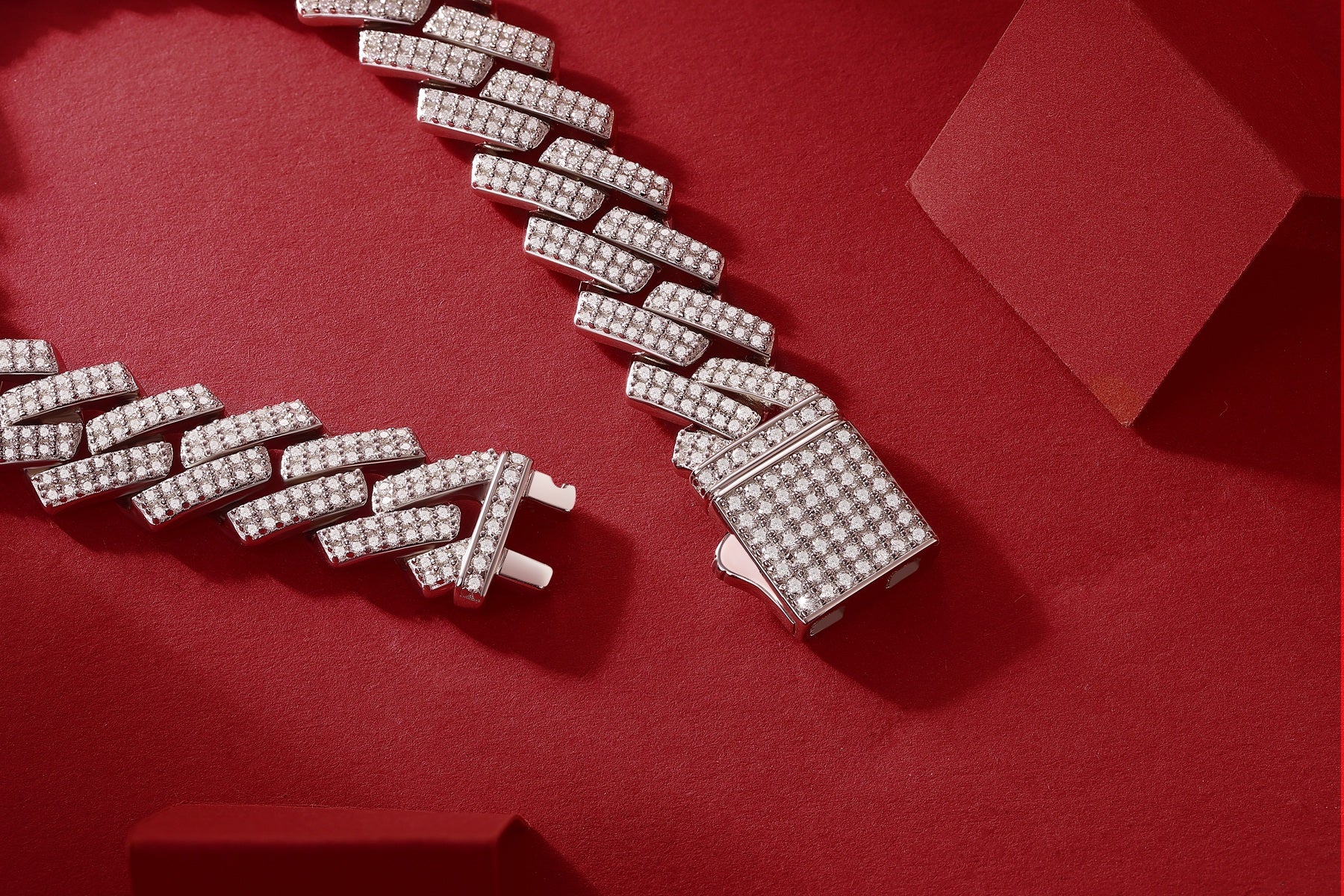 Silver bracelet with diamond accents on a red background