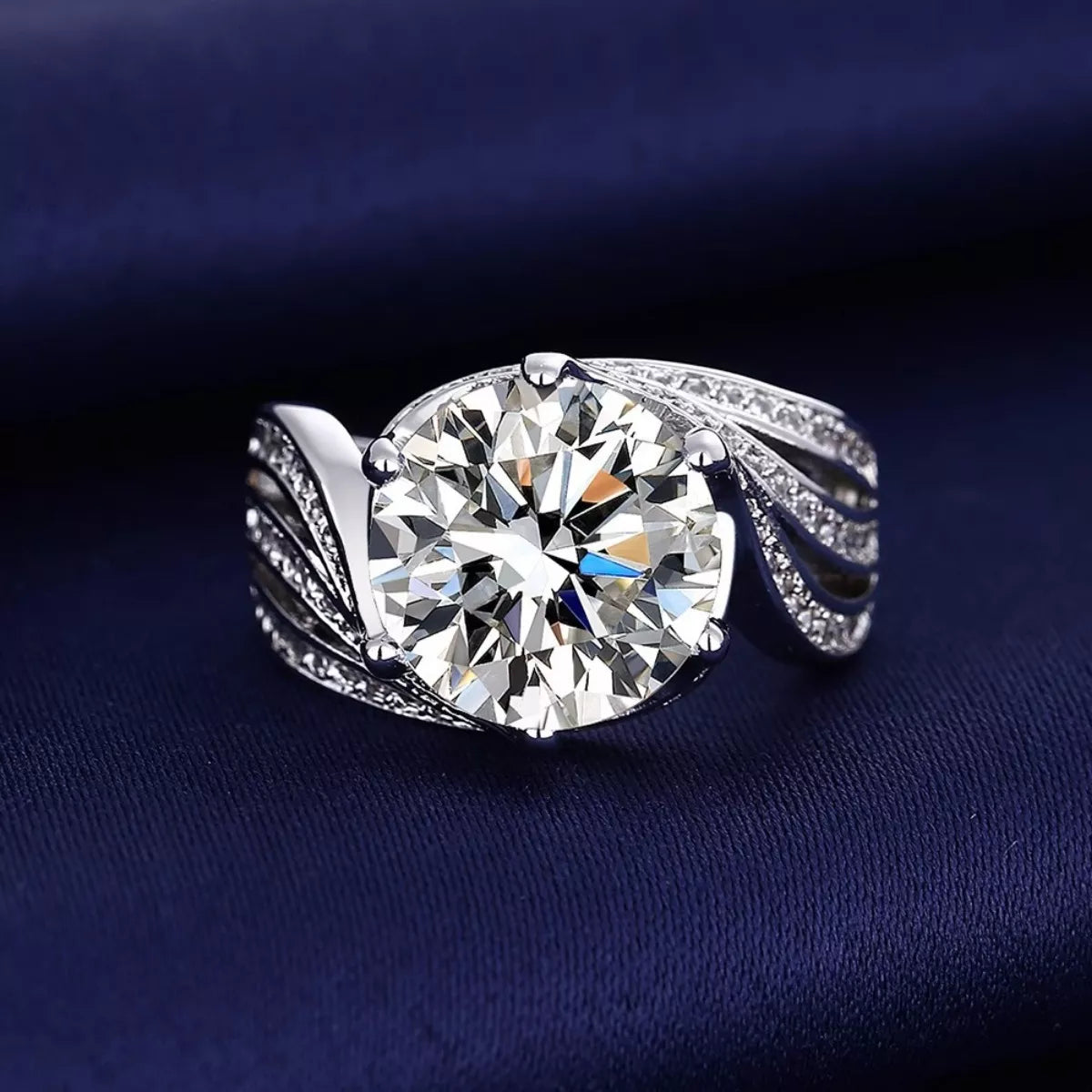 Silver ring with a large diamond on a dark blue background