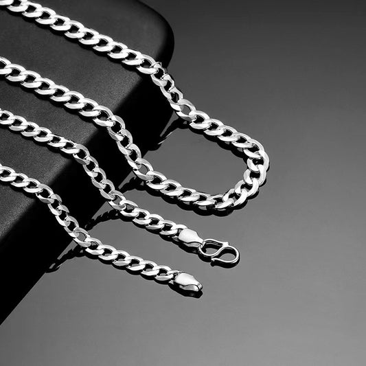 Silver chain necklace on a dark background