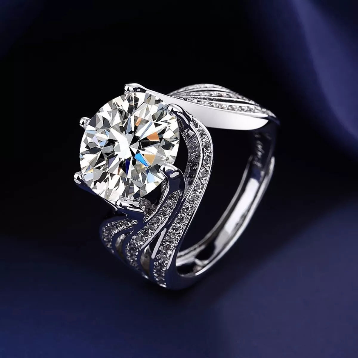 Silver ring with a large diamond on a dark background