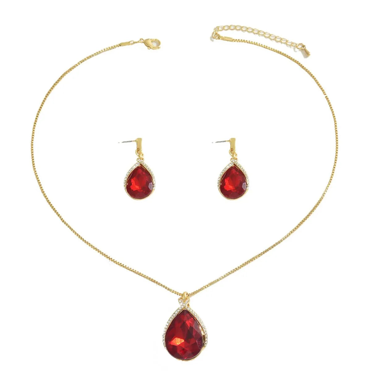 Gold necklace and earrings with red teardrop stones on a white background