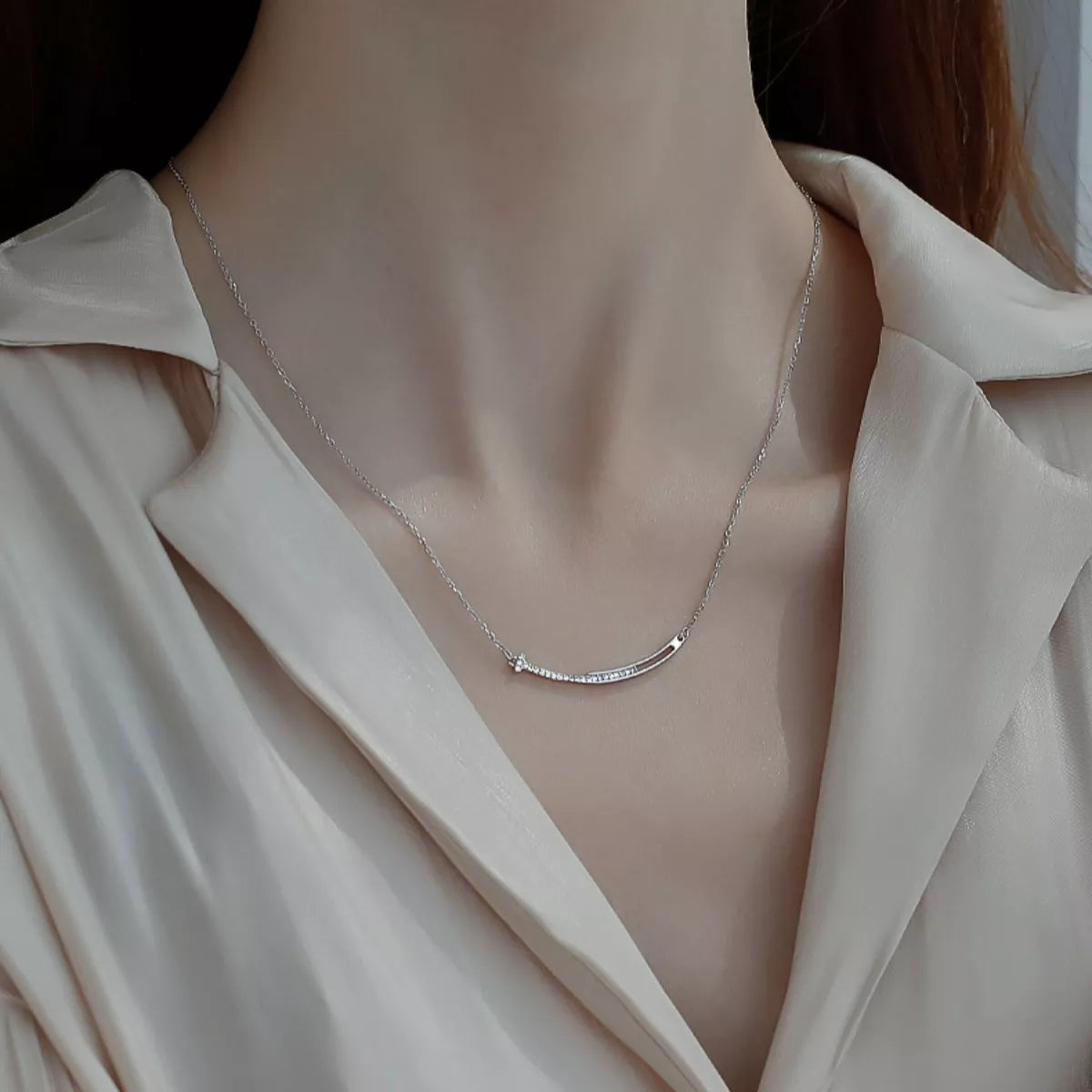 Silver necklace on a mannequin with a beige top
