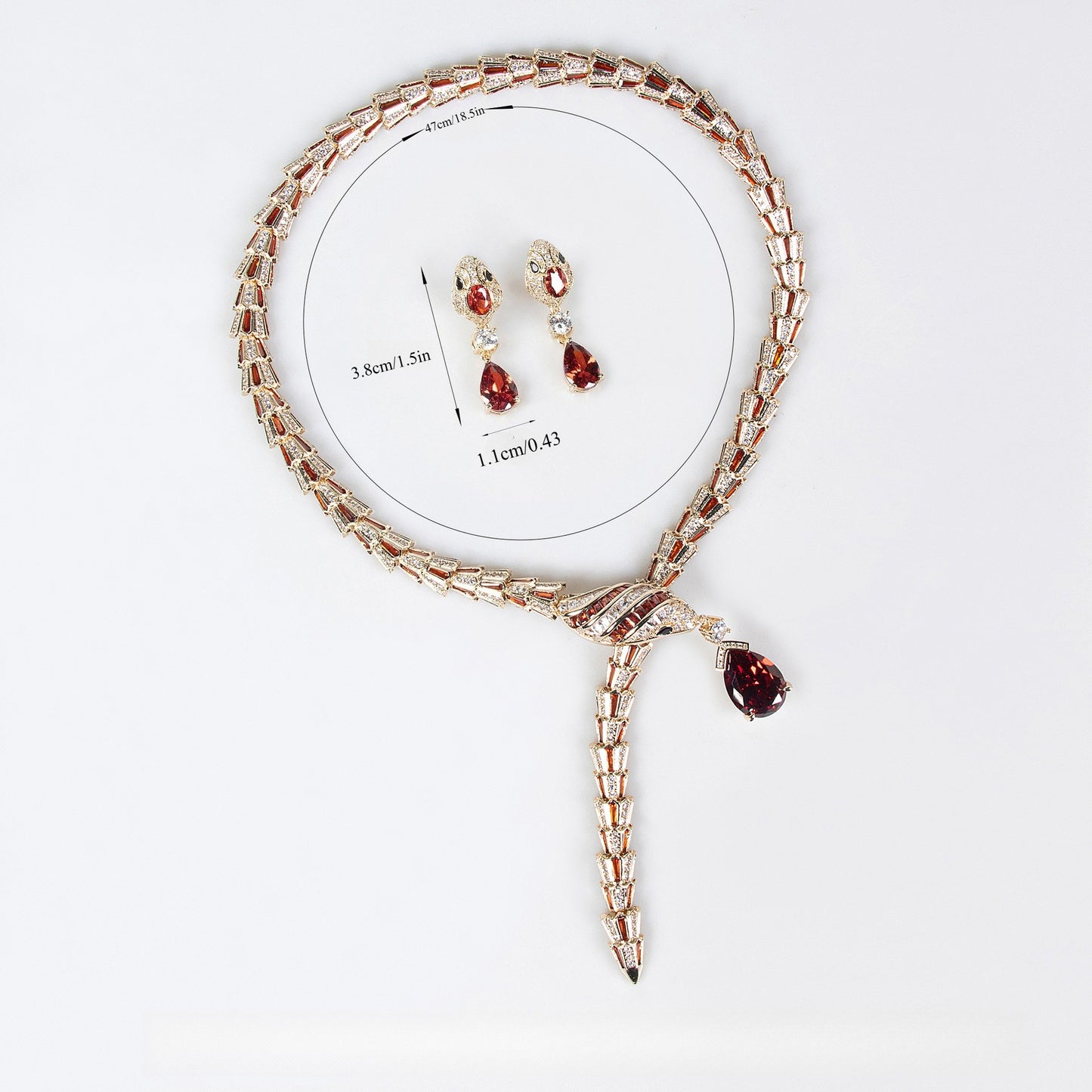 Gold snake necklace and earrings set with red and clear stones, featuring product measurement details.