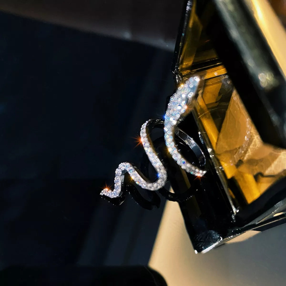 Decorative car emblem with crystals on a black car