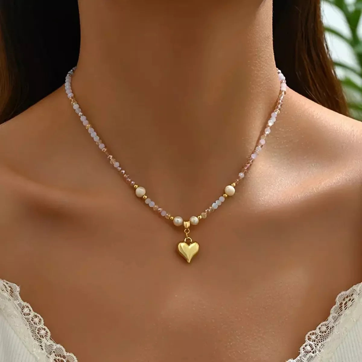 Necklace with a heart pendant worn by a model