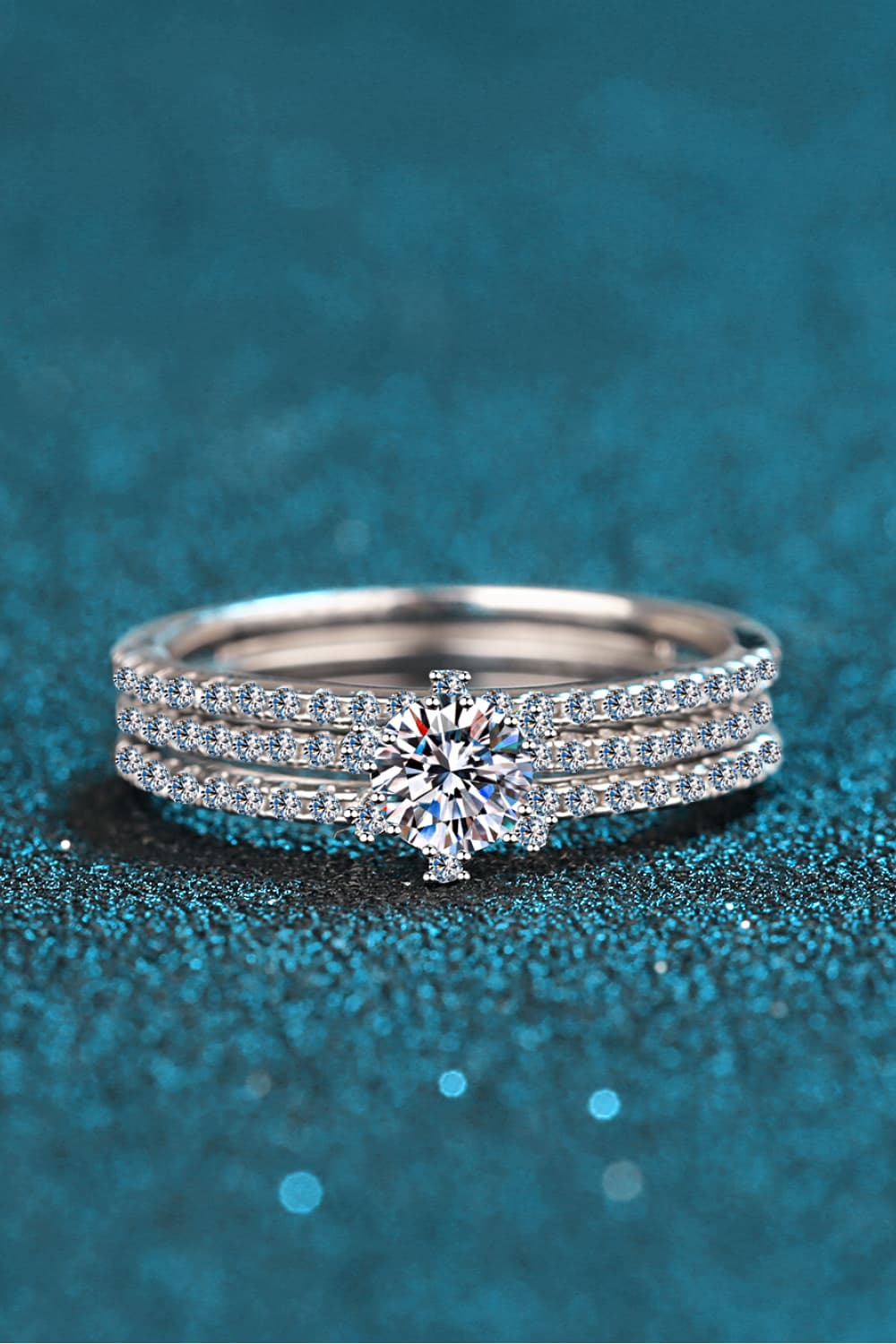 Close-up of a Moissanite 925 Sterling Silver Three-Ring Stack Set featuring a round solitaire and two matching pavé bands on a hand | Le'Var Neilson Jewelry