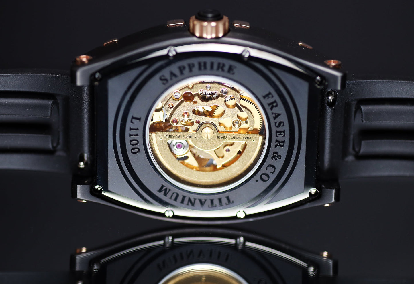 Watch back cover with visible brand name on a dark background