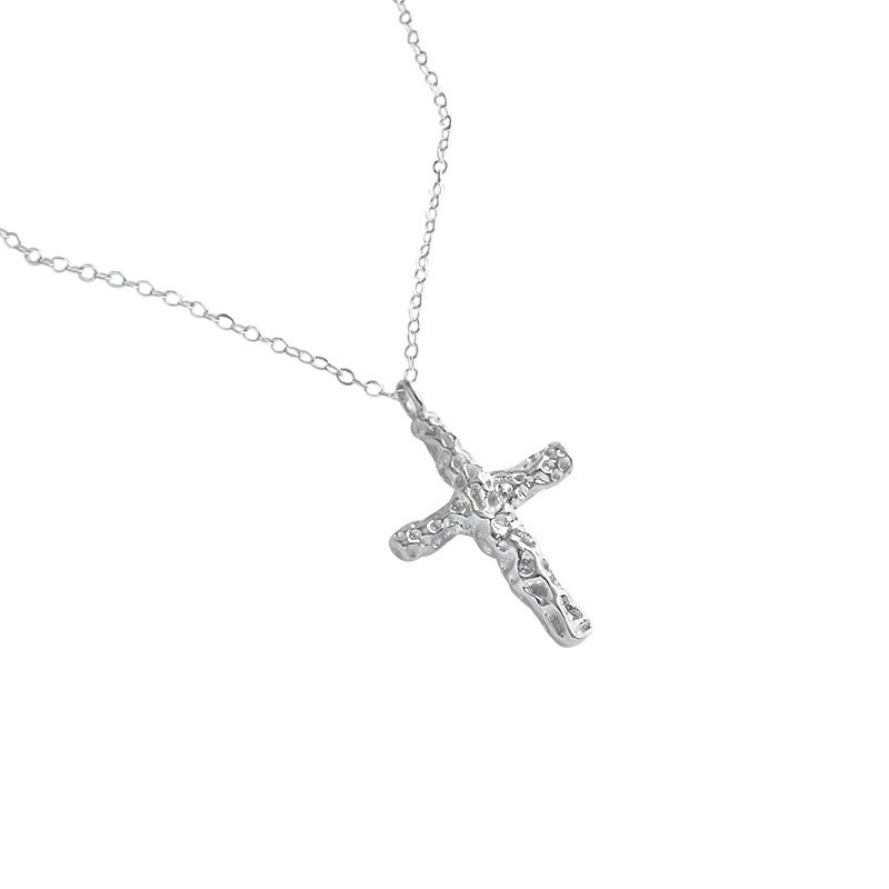 Silver cross necklace on a white background