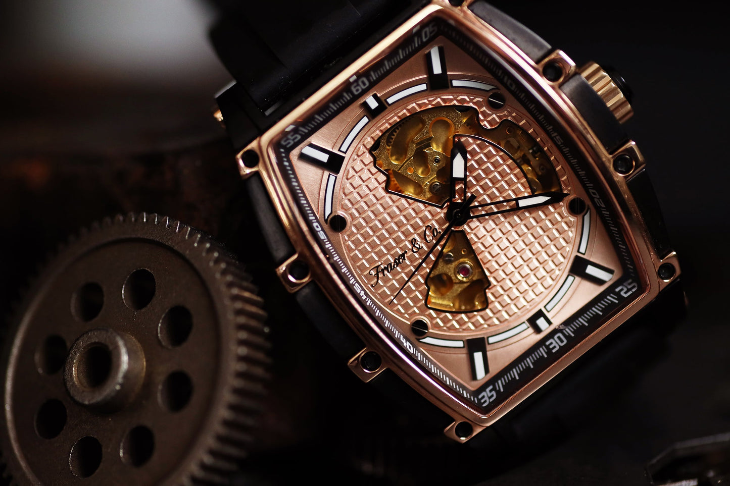 Close-up of a rose gold watch with intricate design and visible gears on a dark background