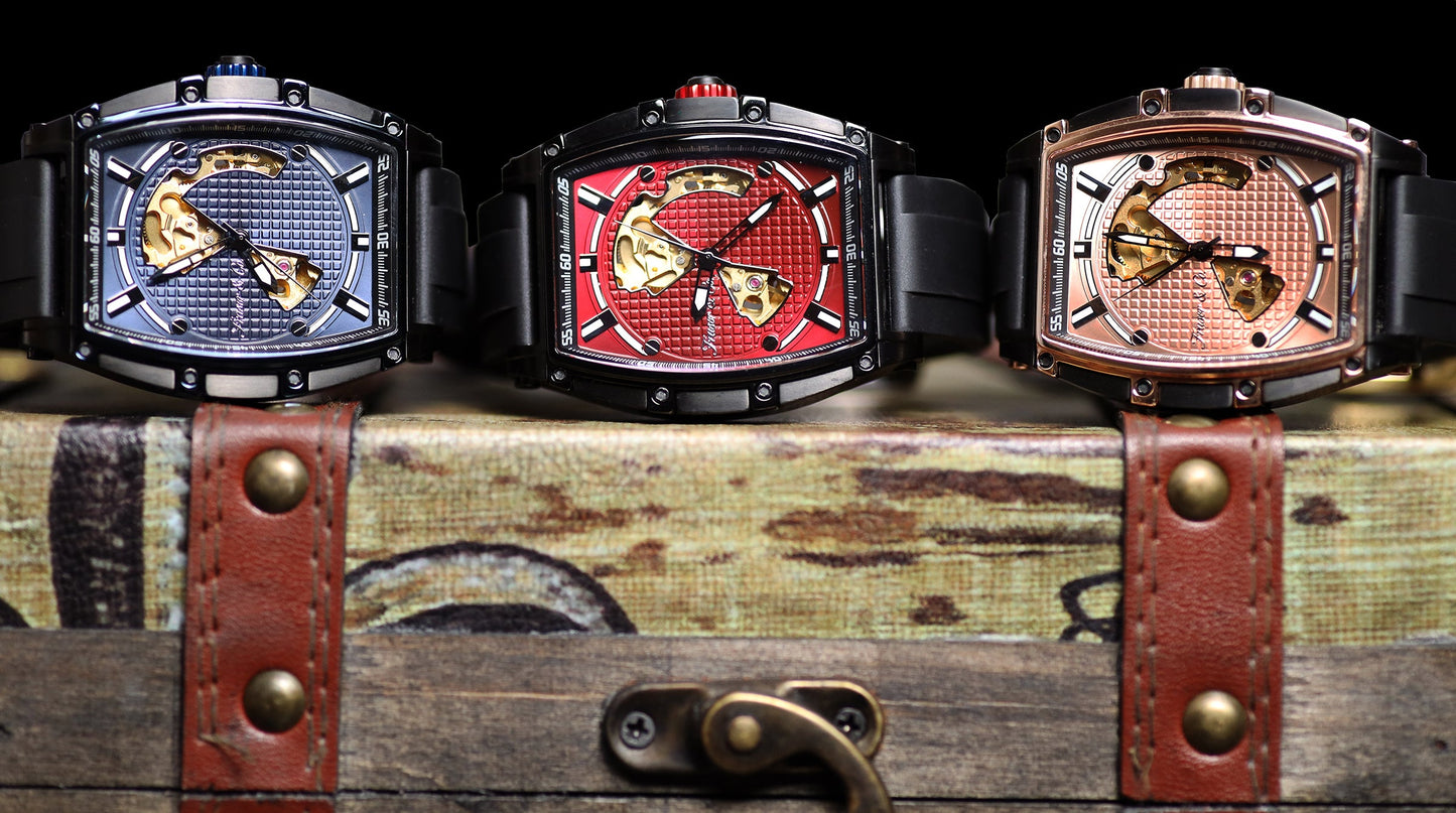 Three watches with unique designs on a wooden chest