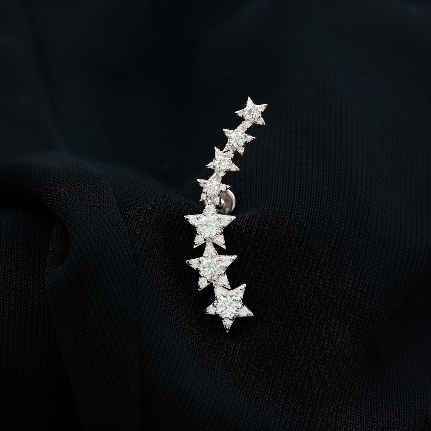 Star-shaped earring on a black background