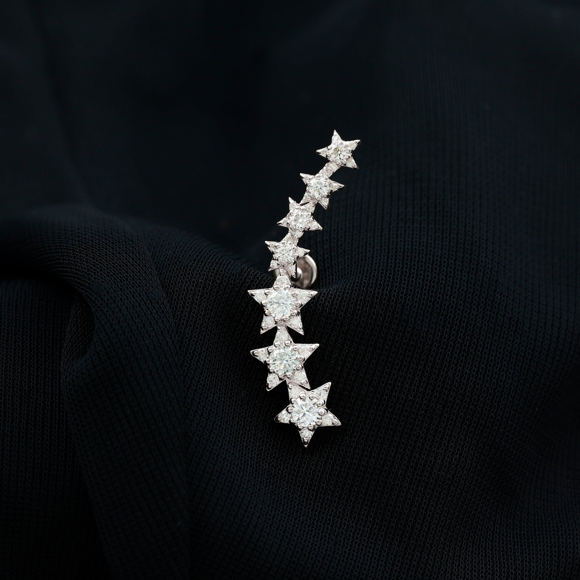Star-shaped earring on a black background