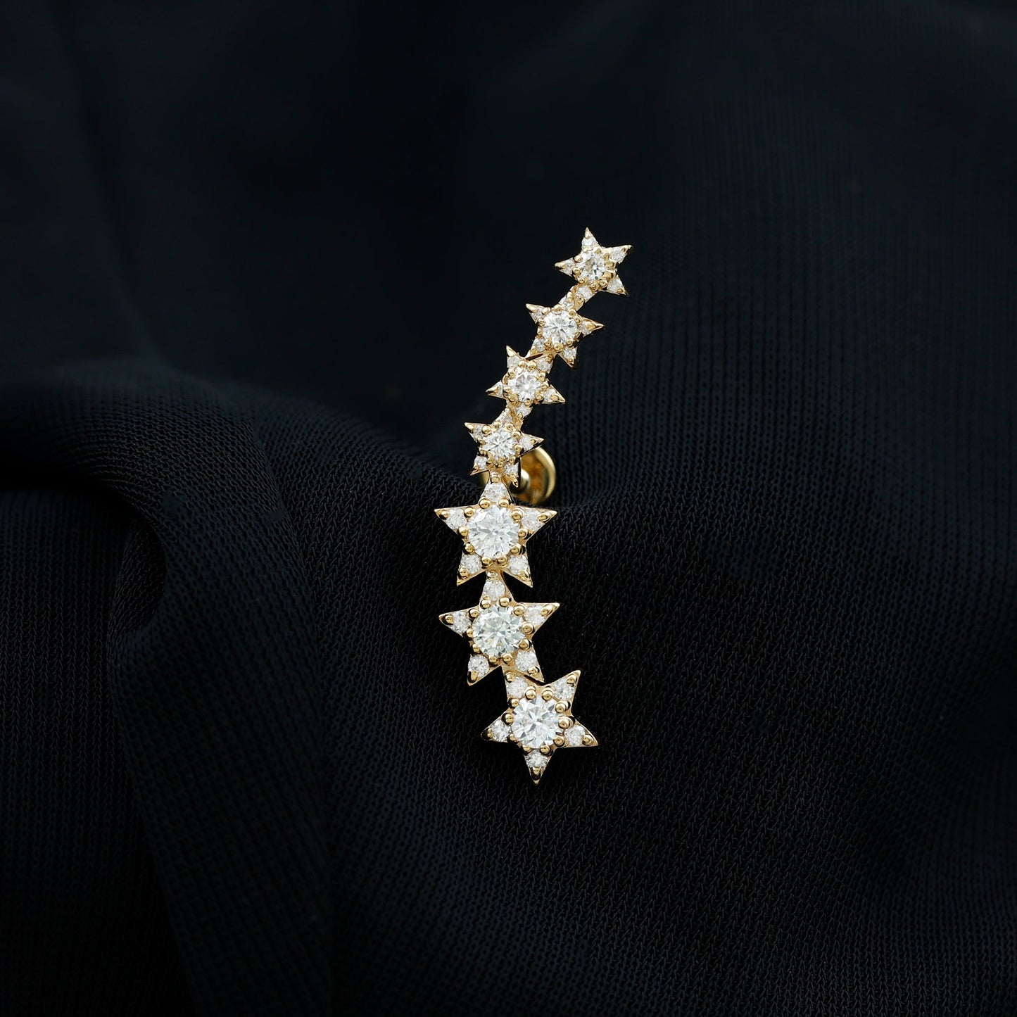 Star-shaped earring on a black background
