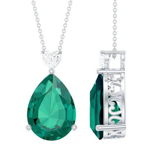 Two green gemstone pendants on silver chains against a white background